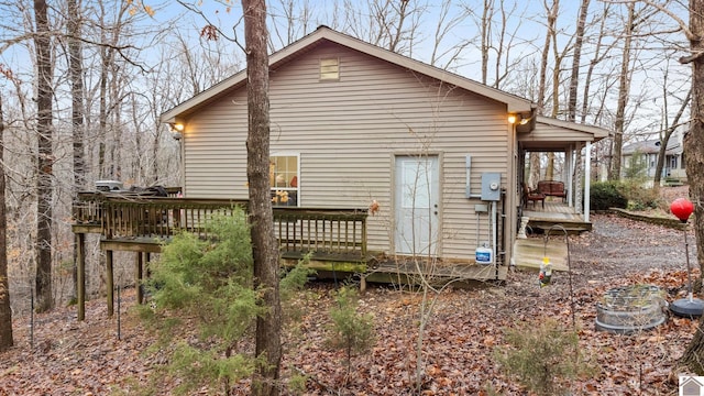 back of house featuring a wooden deck