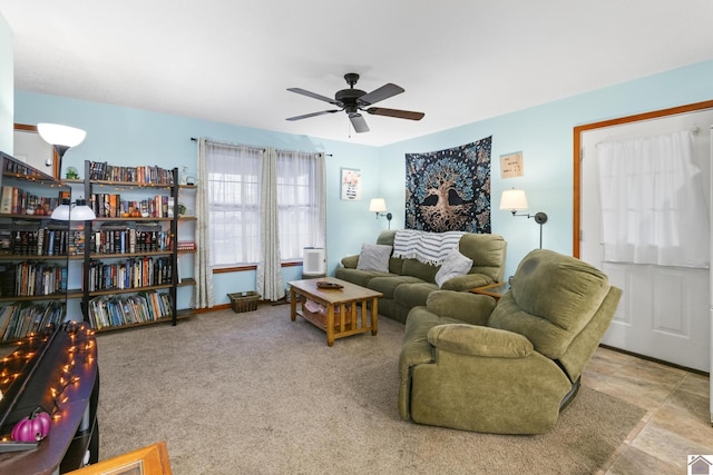 carpeted living room with ceiling fan