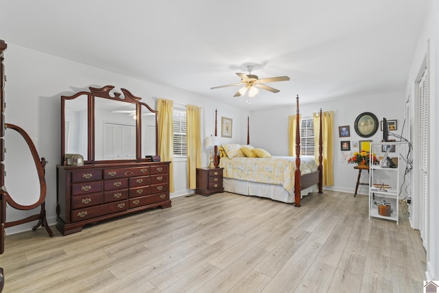 bedroom with ceiling fan, a closet, and light hardwood / wood-style flooring