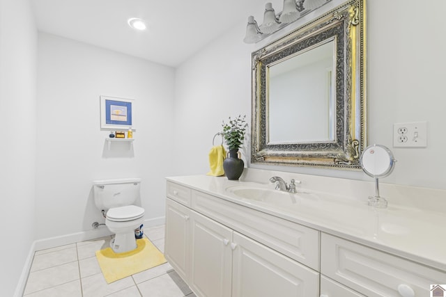 bathroom with toilet, tile patterned floors, and vanity