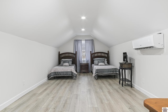 bedroom with light hardwood / wood-style flooring, vaulted ceiling, and a wall mounted air conditioner