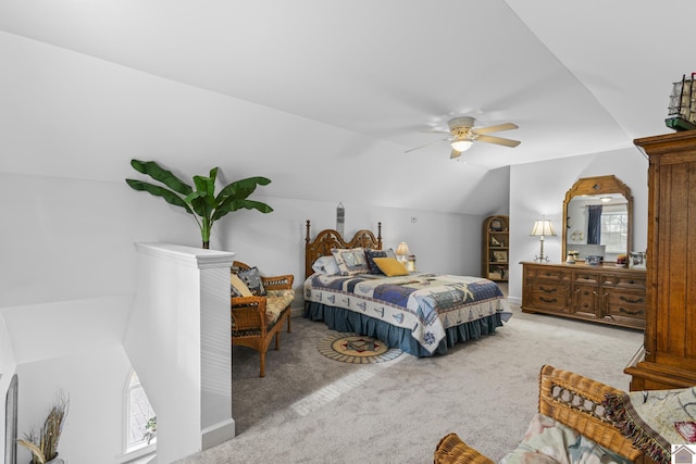 carpeted bedroom featuring ceiling fan, multiple windows, and lofted ceiling