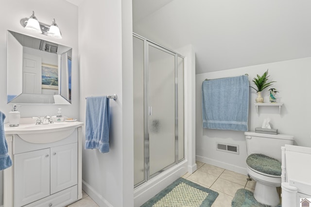 bathroom featuring toilet, vanity, tile patterned flooring, and a shower with door