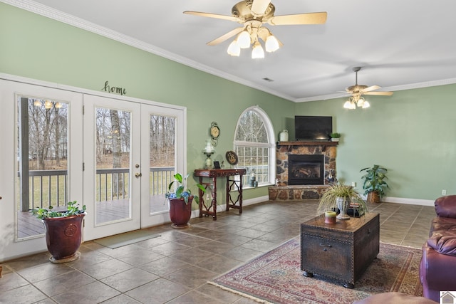 living room featuring ceiling fan, french doors, a fireplace, and crown molding