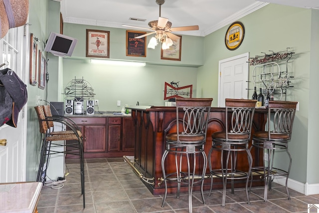 bar with ceiling fan and crown molding