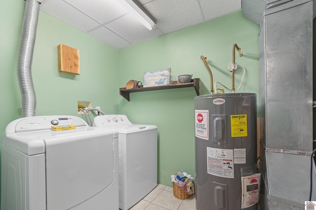 laundry area with water heater, light tile patterned flooring, and washer and clothes dryer