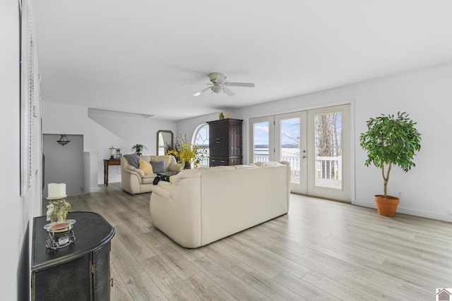 living room with ceiling fan, light hardwood / wood-style flooring, and french doors