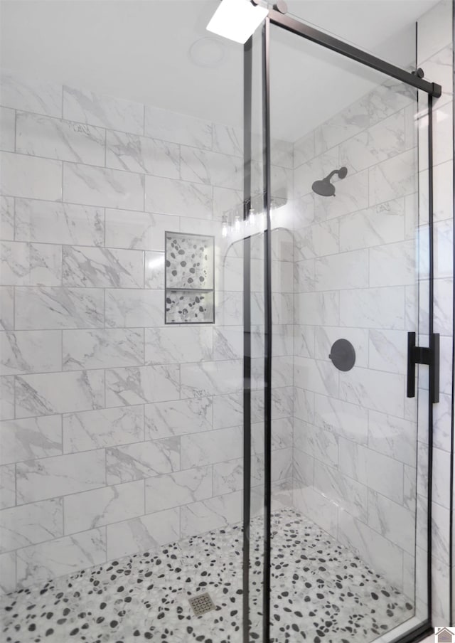 bathroom with a shower with shower door