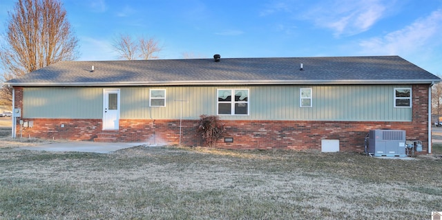 view of property exterior with central AC, a patio, and a yard