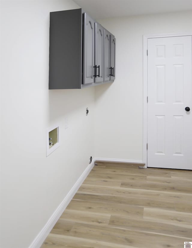 laundry area with cabinets, washer hookup, light hardwood / wood-style flooring, and hookup for an electric dryer