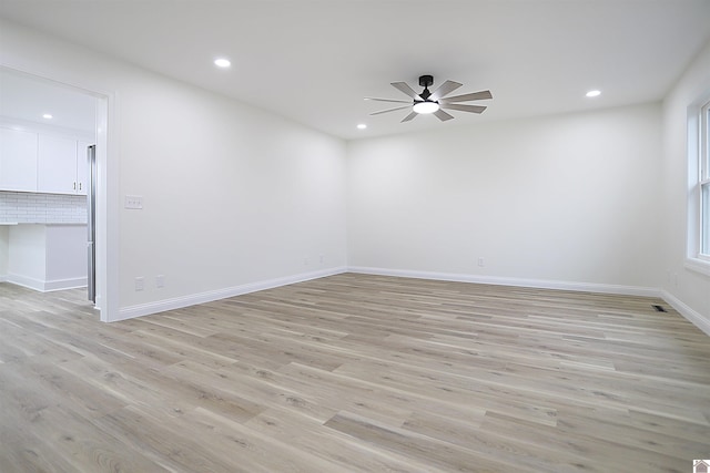 empty room featuring ceiling fan and light hardwood / wood-style floors