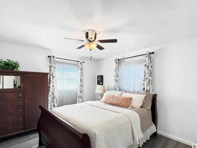 bedroom with ceiling fan and dark wood-type flooring