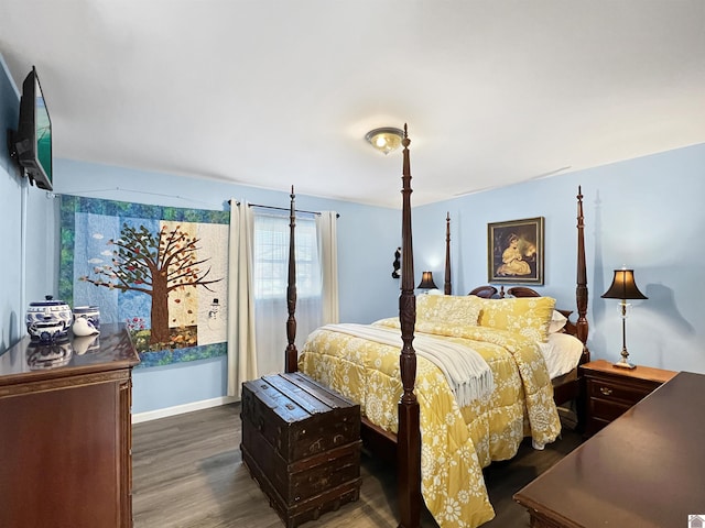 bedroom with dark hardwood / wood-style flooring