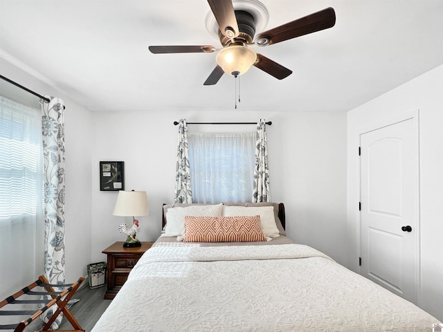 bedroom featuring ceiling fan and dark hardwood / wood-style flooring