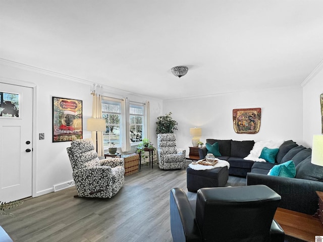 living room with crown molding and hardwood / wood-style flooring