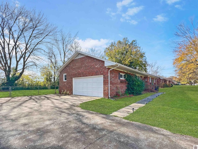 view of side of property with a yard and a garage