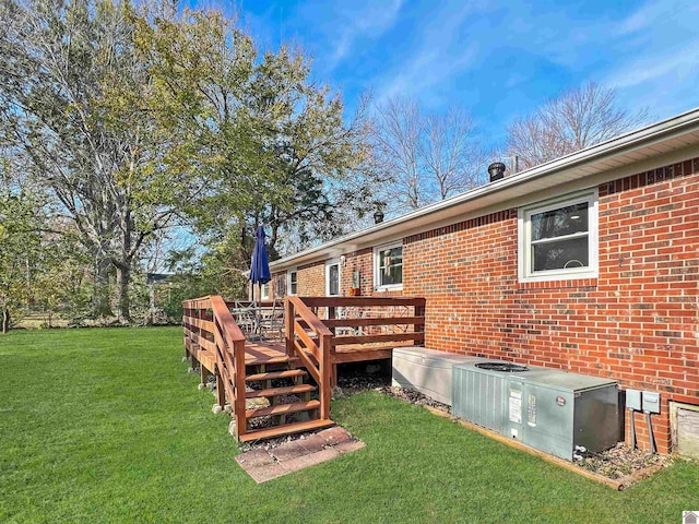 view of yard with a wooden deck and central air condition unit