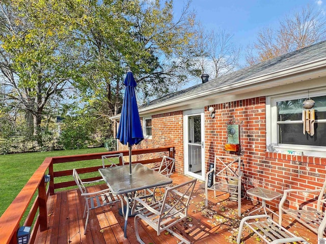 wooden terrace with a yard