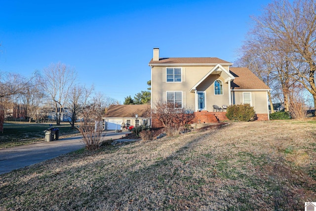 view of front of property with a front lawn and a garage