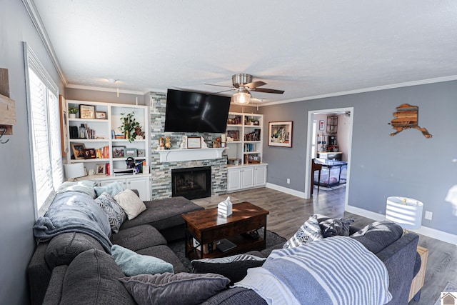 living room featuring dark hardwood / wood-style flooring, crown molding, and a stone fireplace