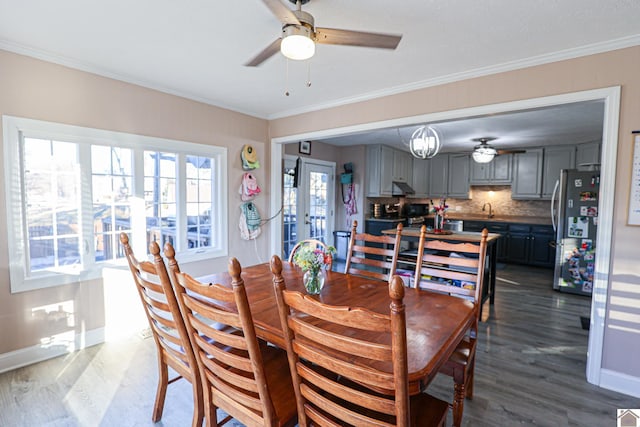 dining area with ceiling fan, french doors, ornamental molding, and hardwood / wood-style floors