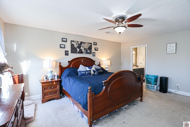 carpeted bedroom with ceiling fan and ensuite bathroom