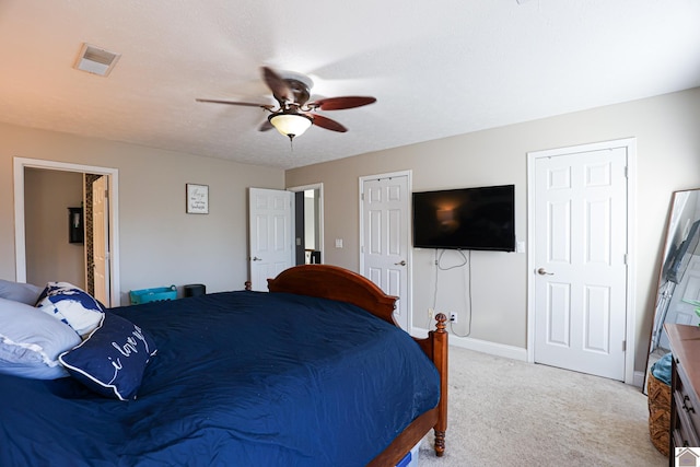 carpeted bedroom featuring a textured ceiling and ceiling fan