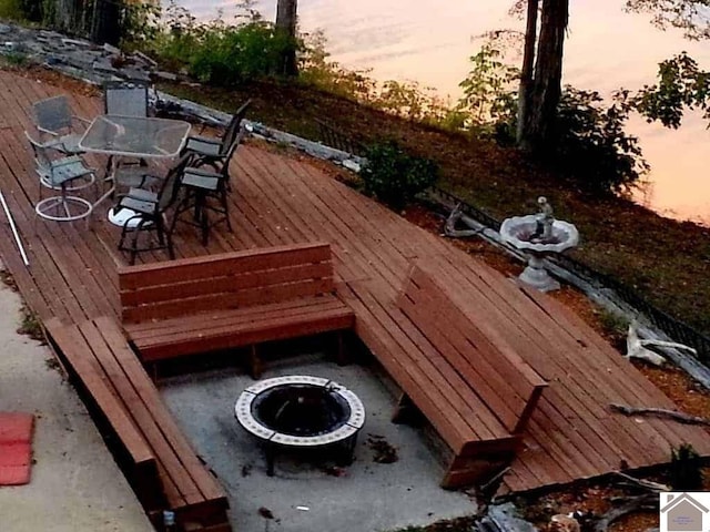 deck at dusk with an outdoor fire pit