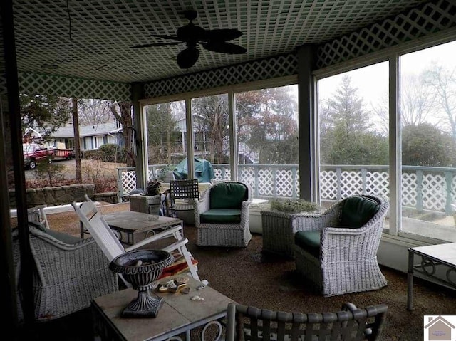 sunroom / solarium featuring ceiling fan