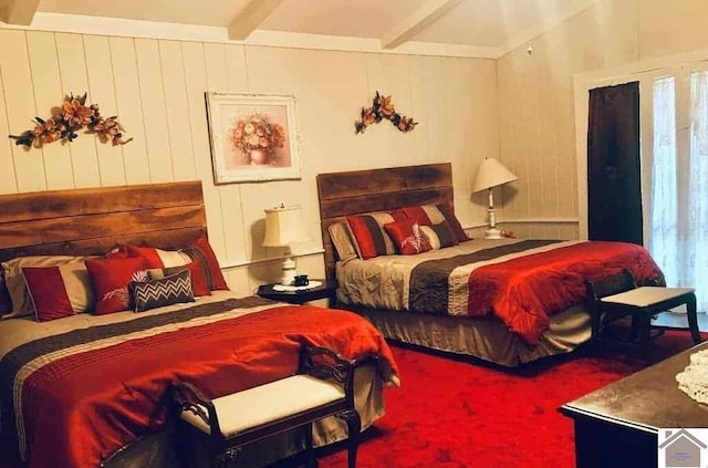 bedroom featuring carpet, beam ceiling, and wooden walls