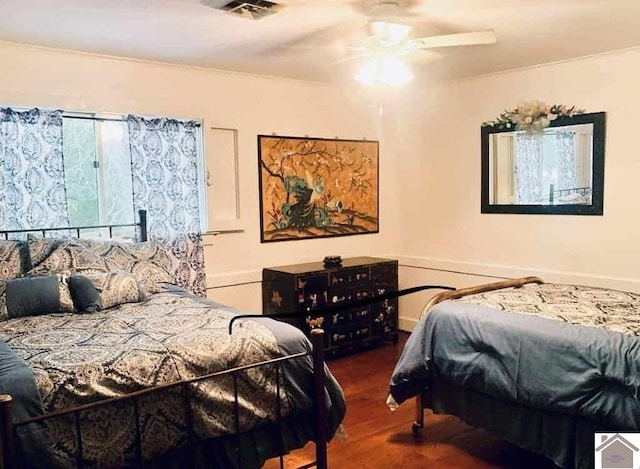 bedroom with ceiling fan and dark wood-type flooring