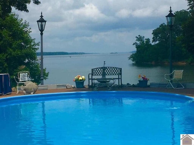 view of swimming pool with a water view