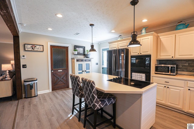 kitchen featuring black appliances, decorative light fixtures, decorative backsplash, and a textured ceiling