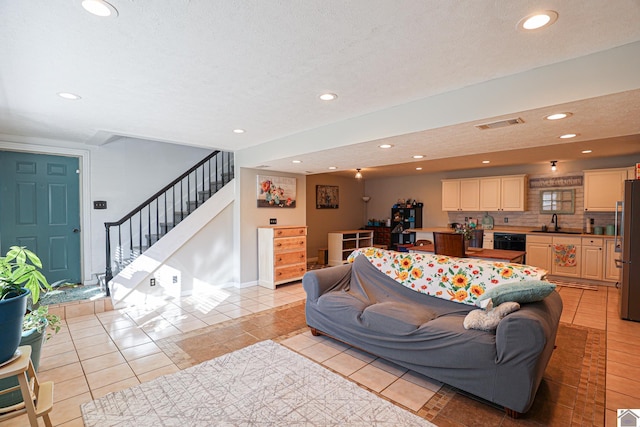 living room with light tile patterned floors and sink