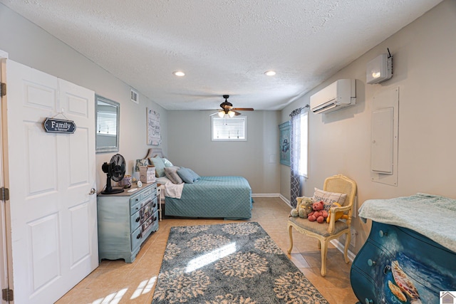 bedroom with ceiling fan, electric panel, light tile patterned flooring, a wall mounted air conditioner, and a textured ceiling