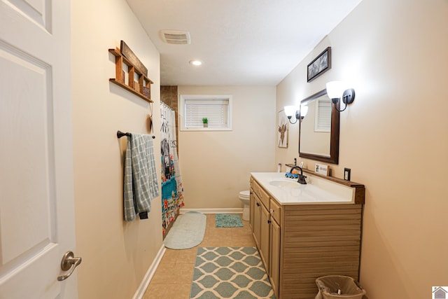 bathroom with toilet, vanity, tile patterned flooring, and a shower with curtain