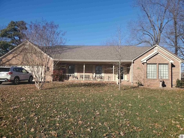 ranch-style house featuring a garage, a front lawn, and a porch