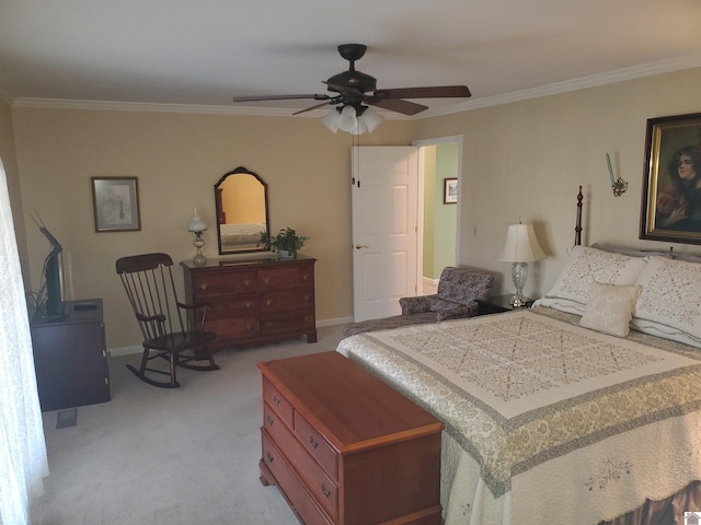 carpeted bedroom featuring ceiling fan and crown molding