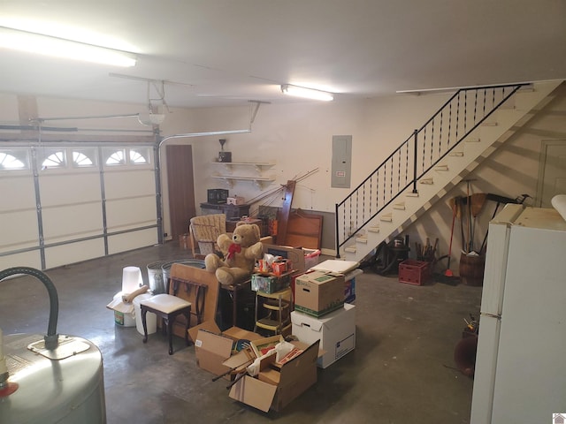 garage featuring white refrigerator and electric panel