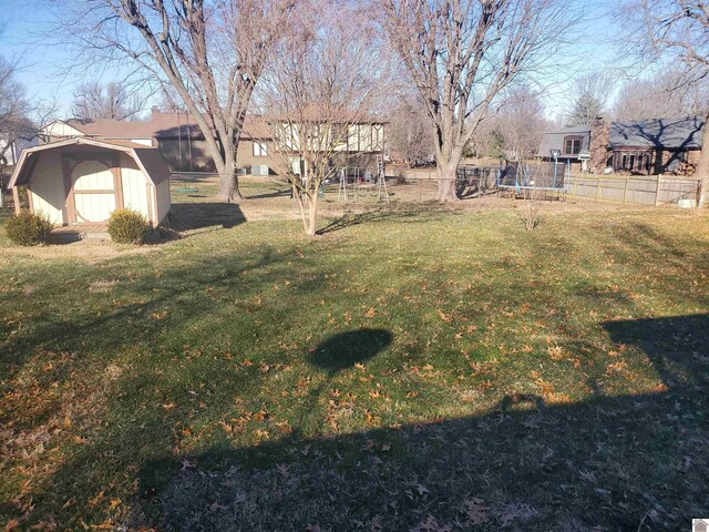 view of yard with a storage unit and a trampoline