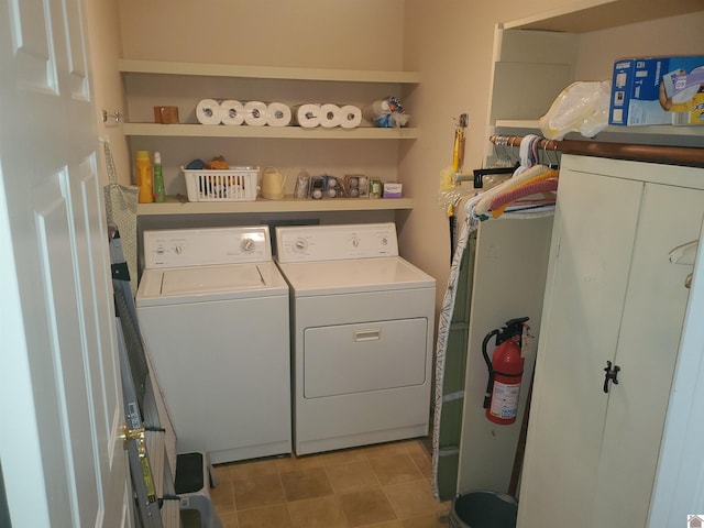 clothes washing area with water heater and independent washer and dryer