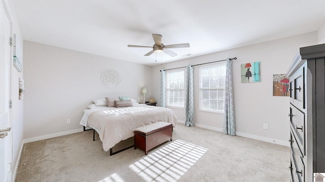 bedroom with ceiling fan and light colored carpet