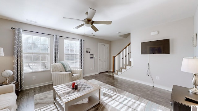 living room with ceiling fan and dark hardwood / wood-style flooring