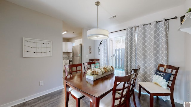 dining room with dark hardwood / wood-style flooring