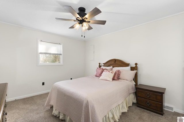 carpeted bedroom with ceiling fan and crown molding