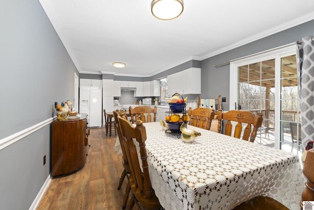 dining room with dark wood-type flooring and ornamental molding