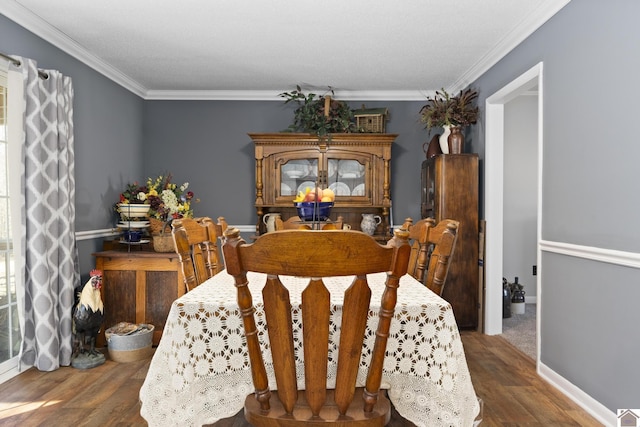 dining space featuring dark hardwood / wood-style flooring and crown molding