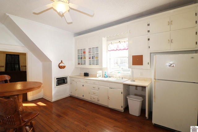 kitchen featuring white cabinetry, dark hardwood / wood-style floors, and white refrigerator