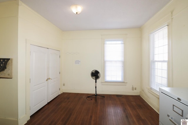 unfurnished room with dark wood-type flooring