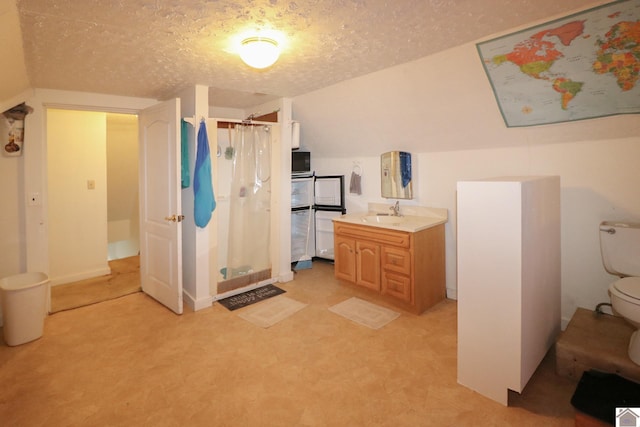 bathroom with lofted ceiling, vanity, toilet, walk in shower, and a textured ceiling